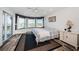 Main bedroom featuring a bay window, balcony access, and wood look floors at 199 21St Ave, St Pete Beach, FL 33706