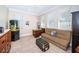 Bright home office with a large desk, cozy sofa, and ample natural light from multiple windows at 199 21St Ave, St Pete Beach, FL 33706