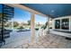 Covered patio with tile flooring, spiral staircase, and comfortable seating overlooking the serene waterfront at 199 21St Ave, St Pete Beach, FL 33706