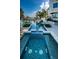 Stunning pool featuring blue tile and stepping stones, surrounded by lush landscaping, perfect for relaxation at 199 21St Ave, St Pete Beach, FL 33706