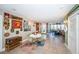 Spacious recreation room with dining area, decorated walls, tile flooring, and access to an outdoor patio at 199 21St Ave, St Pete Beach, FL 33706