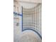 Close-up of a unique glass block shower design with blue trim, showcasing its elegant and functional construction at 199 21St Ave, St Pete Beach, FL 33706