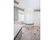 Modern bathroom featuring a curved glass block shower with tiled trim, offering both style and privacy at 199 21St Ave, St Pete Beach, FL 33706