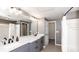Bathroom showcasing double vanity with marble countertops, shower with tub, and access to walk in closet at 2010 E Palm Ave # 14206, Tampa, FL 33605