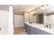 Bathroom featuring a double vanity, marble countertops, shower/tub, and a closet at 2010 E Palm Ave # 14206, Tampa, FL 33605