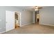 Bedroom features neutral walls, carpet, ceiling fan, and view into kitchen and bathroom at 2010 E Palm Ave # 14206, Tampa, FL 33605