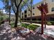 Well-maintained common area featuring a grill and outdoor seating, surrounded by mature trees at 2010 E Palm Ave # 14206, Tampa, FL 33605