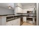 An updated kitchen with stainless steel appliances, granite countertops, and a ceiling fan at 2010 E Palm Ave # 14206, Tampa, FL 33605