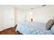 Bright bedroom featuring wood floors, a large bed, and an attached bathroom at 2044 Greenwood Valley Dr, Plant City, FL 33563