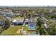 An aerial view of a cozy home with a screened pool, surrounded by a fenced yard and lush greenery at 2851 16Th N Ave, St Petersburg, FL 33713
