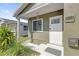 Charming home entrance with a secure white door, green exterior and manicured landscaping at 2851 16Th N Ave, St Petersburg, FL 33713