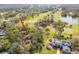 Aerial view of home located on a golf course with mature landscaping at 29318 Whipporwill Ln, Wesley Chapel, FL 33543