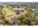 Aerial view of home adjacent to a golf course and water feature at 29318 Whipporwill Ln, Wesley Chapel, FL 33543