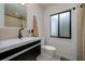 Modern bathroom featuring sleek fixtures, contemporary vanity, and a frosted privacy window at 29318 Whipporwill Ln, Wesley Chapel, FL 33543