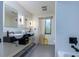 Modern bathroom with floating vanity, black fixtures, two mirrors, and a view out of the window at 29318 Whipporwill Ln, Wesley Chapel, FL 33543