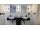 Elegant bathroom featuring dual vessel sinks with modern fixtures and stylish lighting at 29318 Whipporwill Ln, Wesley Chapel, FL 33543