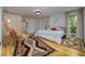Cozy bedroom featuring hardwood floors, vibrant decor, and ample natural light at 29318 Whipporwill Ln, Wesley Chapel, FL 33543