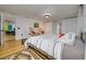 Bright bedroom showcasing hardwood floors, two woven chairs and access to the living spaces at 29318 Whipporwill Ln, Wesley Chapel, FL 33543