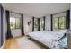 Bright bedroom with hardwood floors and several windows offering ample natural light and outdoor views at 29318 Whipporwill Ln, Wesley Chapel, FL 33543