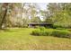 Beautiful property featuring a well-manicured lawn and mature landscaping at 29318 Whipporwill Ln, Wesley Chapel, FL 33543