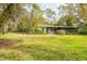 Well-maintained home with neutral siding and a lush green lawn at 29318 Whipporwill Ln, Wesley Chapel, FL 33543