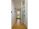 Hallway with wood floors and a view of the backyard through the glass paneled back door at 29318 Whipporwill Ln, Wesley Chapel, FL 33543