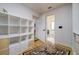Hallway with natural hardwood floors and views into a walk-in closet and bathroom at 29318 Whipporwill Ln, Wesley Chapel, FL 33543