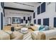 The living room features modern lighting, plush seating, and stylish decor including acoustic panels for sound control at 29318 Whipporwill Ln, Wesley Chapel, FL 33543