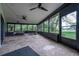 Spacious screened porch with stone floors, outdoor seating, and scenic views of the golf course at 29318 Whipporwill Ln, Wesley Chapel, FL 33543