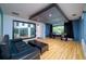 Inside a soundproofed studio with hardwood floors, large window view to living space, and a professional recording setup at 29318 Whipporwill Ln, Wesley Chapel, FL 33543