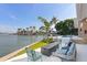 Beautiful backyard area with waterfront views, a cozy outdoor seating area, and well-maintained greenery at 4900 59Th S Ave, St Petersburg, FL 33715