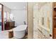 Luxury bathroom with a marble walk-in shower, soaking tub, and stylish vanity with modern fixtures at 4900 59Th S Ave, St Petersburg, FL 33715