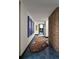 Hallway with brick accent wall, blue floors, and unique rug at 4900 59Th S Ave, St Petersburg, FL 33715