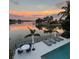 Relaxing poolside with stunning sunset views over the water, plus lounge chairs and dining space at 4900 59Th S Ave, St Petersburg, FL 33715