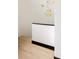 Minimalist staircase featuring light wood floors, a white wall, and a decorative gold mobile at 4900 59Th S Ave, St Petersburg, FL 33715