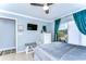 This bedroom features access to the patio, a ceiling fan and light blue walls at 5004 Paloma Dr, Tampa, FL 33624