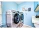 Modern laundry room with a front-loading washer and dryer set, plus ample natural light at 5004 Paloma Dr, Tampa, FL 33624