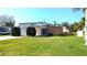 Well-maintained front yard and single story home with a vibrant lawn and beautiful landscaping at 602 Danube Ave, Tampa, FL 33606