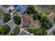 A single-story house sits on a well-manicured lot surrounded by mature trees, providing privacy and shade at 603 S Sylvan Dr, Brandon, FL 33510