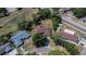 Aerial view of a brick home with a brown roof, surrounded by mature trees and neighborhood at 603 S Sylvan Dr, Brandon, FL 33510