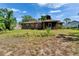 Expansive backyard with a brick home, mature trees and screened-in porch at 603 S Sylvan Dr, Brandon, FL 33510