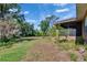 The backyard features a screened-in patio, mature trees and a lush, spacious yard at 603 S Sylvan Dr, Brandon, FL 33510