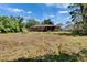 The backyard features a screened-in patio, a brick home, mature trees and a lush, spacious yard at 603 S Sylvan Dr, Brandon, FL 33510