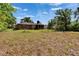 The house has a large backyard with trees and the house has a screened-in porch at 603 S Sylvan Dr, Brandon, FL 33510
