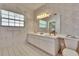 Bathroom featuring a double vanity with plenty of storage and natural light from the window at 603 S Sylvan Dr, Brandon, FL 33510