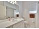 Bright bathroom featuring a white vanity, tiled floors, a matching toilet, and a tiled shower behind a curtain at 603 S Sylvan Dr, Brandon, FL 33510