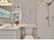 Bathroom featuring a sink and white-tiled shower with gold fixtures at 603 S Sylvan Dr, Brandon, FL 33510