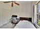 This bedroom features a ceiling fan, closet, and large window with views and lots of light from the exterior at 603 S Sylvan Dr, Brandon, FL 33510