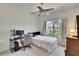 This bedroom offers a ceiling fan, bright light from the exterior, and a comfortable spot for sleeping or working at 603 S Sylvan Dr, Brandon, FL 33510