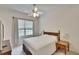 Neutral bedroom with large bed, ceiling fan and window with bright natural light at 603 S Sylvan Dr, Brandon, FL 33510